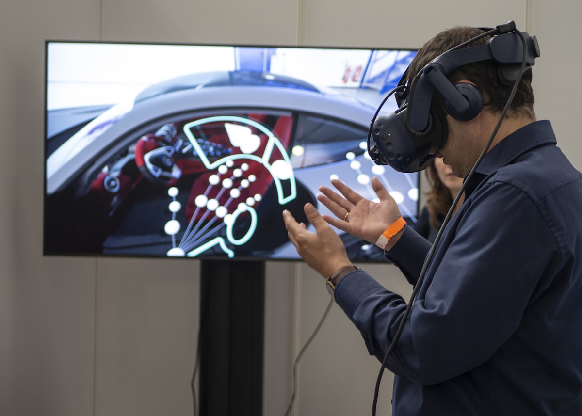A person gesturing inside a virtual reality experience, interacting with a live digital model